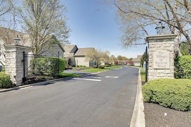 view of street with street lighting, a residential view, and curbs