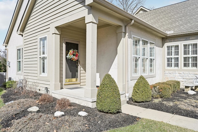 doorway to property featuring a shingled roof and central air condition unit