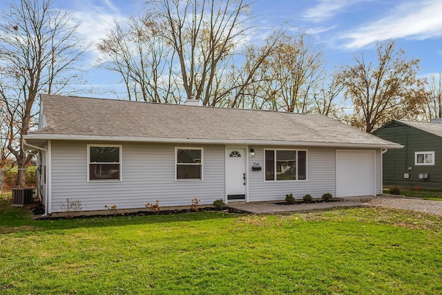 ranch-style home featuring an attached garage, cooling unit, driveway, roof with shingles, and a front lawn