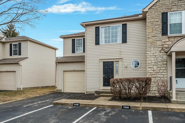 view of front of home featuring uncovered parking and stone siding