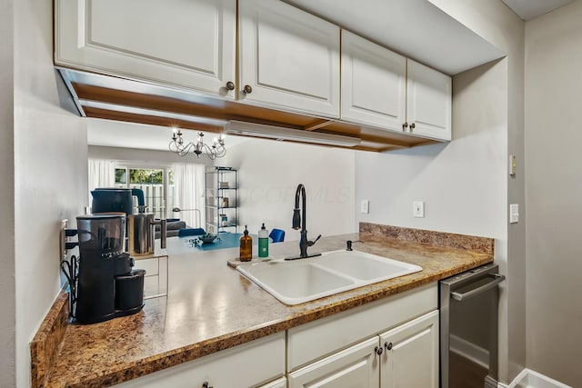 kitchen featuring white cabinetry and a sink