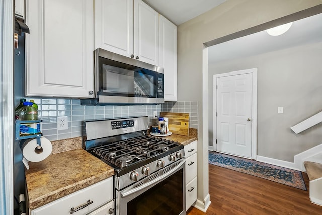 kitchen with stainless steel appliances, dark wood-type flooring, backsplash, and white cabinets