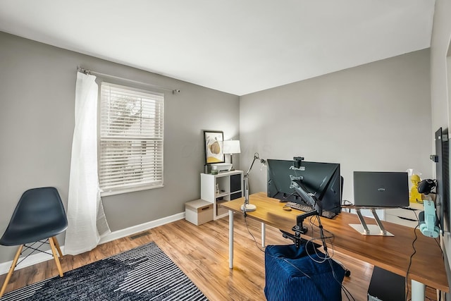 office with visible vents, baseboards, and wood finished floors