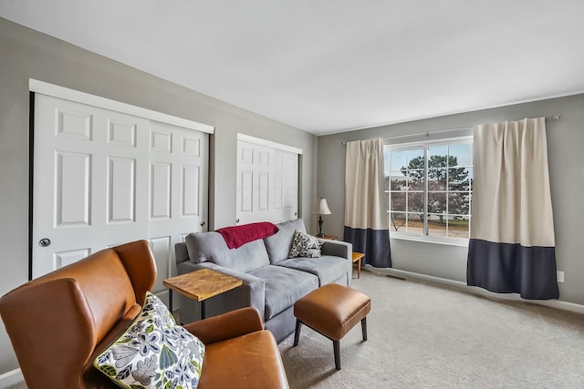 carpeted living room featuring baseboards