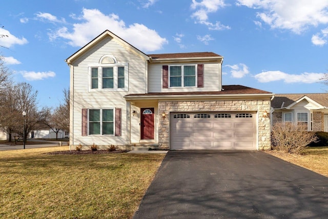 traditional home with a garage, a front yard, stone siding, and driveway