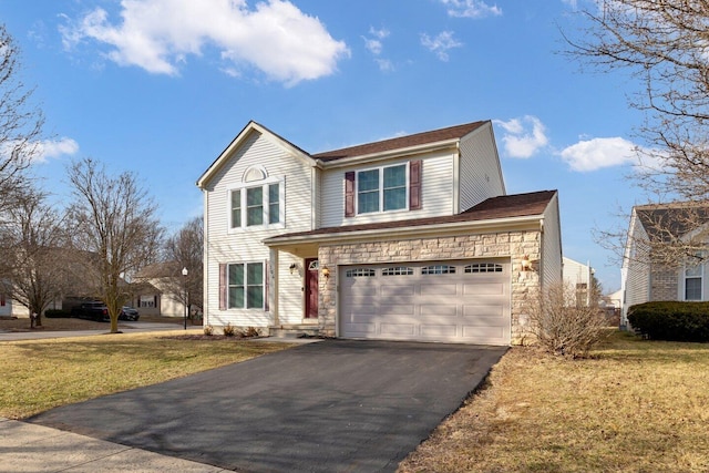 traditional home featuring a garage, stone siding, aphalt driveway, and a front yard