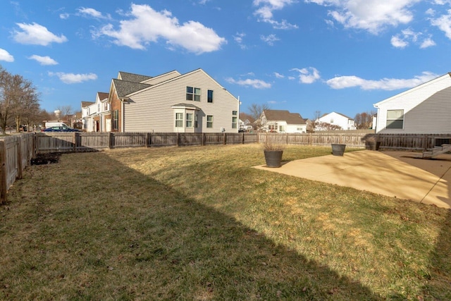 view of yard featuring a patio, a fenced backyard, and a residential view