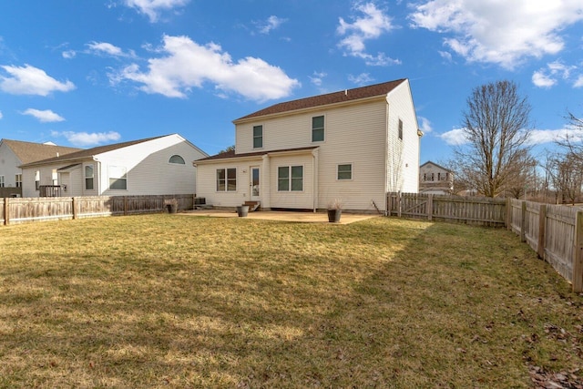 rear view of property with a yard, a patio, and a fenced backyard