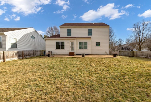 rear view of house with entry steps, a fenced backyard, a lawn, and a patio