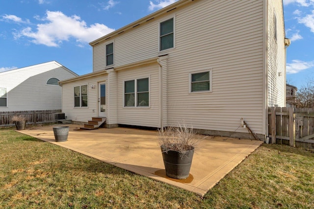 back of house with entry steps, a patio, fence, cooling unit, and a yard