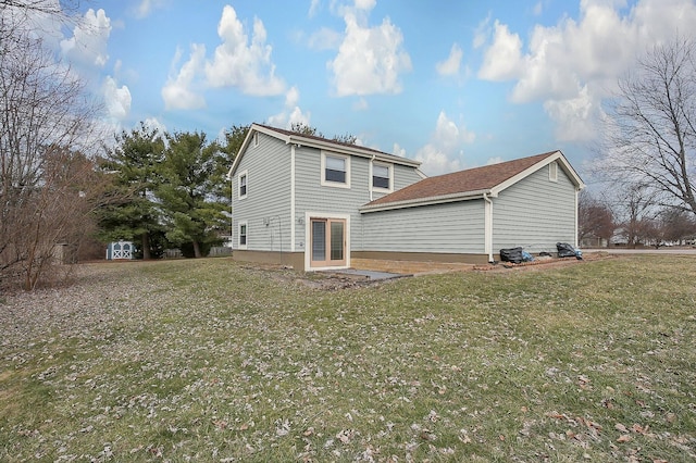 rear view of property featuring a yard