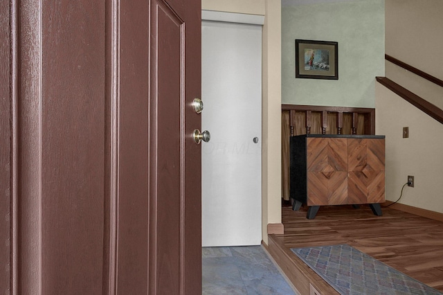 interior space with baseboards and wood finished floors