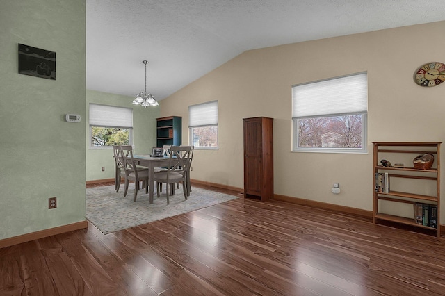 dining room with a textured ceiling, a notable chandelier, baseboards, vaulted ceiling, and wood-type flooring