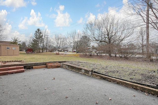 view of yard with an outbuilding and a shed