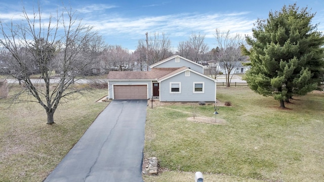 ranch-style home featuring an attached garage, aphalt driveway, and a front lawn