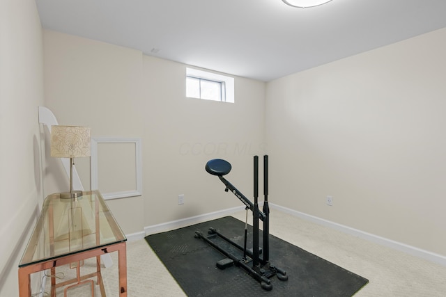 workout room featuring baseboards and carpet flooring