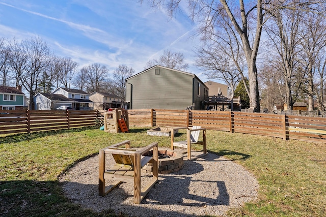 view of yard featuring fence and a fire pit