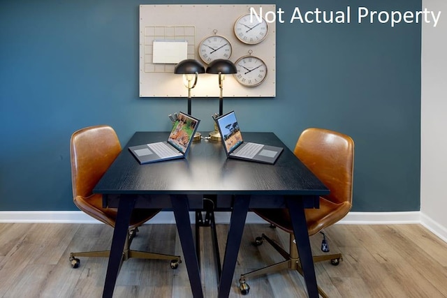 home office with baseboards and wood finished floors