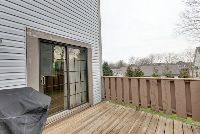 wooden terrace with a grill