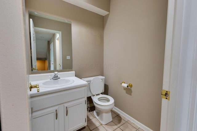 bathroom with baseboards, vanity, toilet, and tile patterned floors