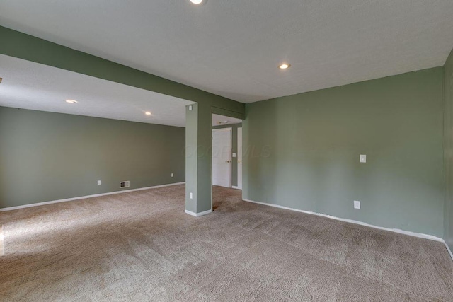 empty room featuring recessed lighting, carpet flooring, visible vents, and baseboards