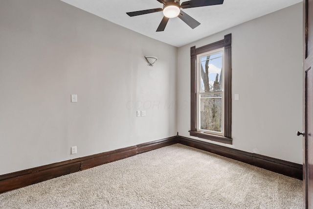 empty room with ceiling fan, carpet, and baseboards