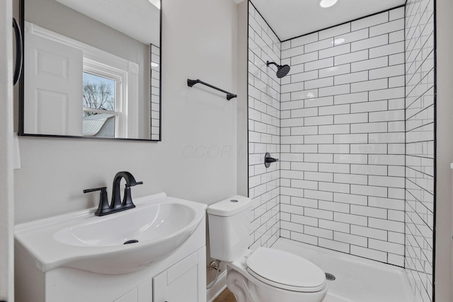 full bathroom featuring toilet, a shower stall, and vanity