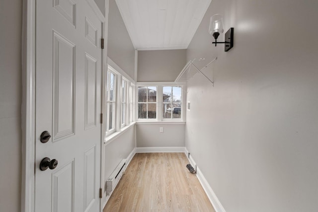 spacious closet featuring a baseboard heating unit and light wood finished floors