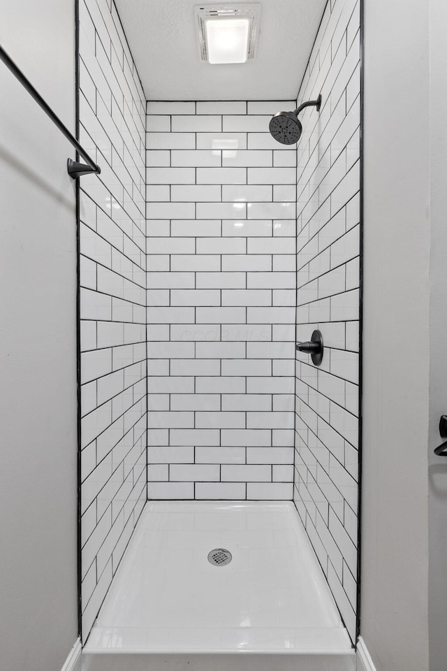 bathroom with visible vents and a shower stall