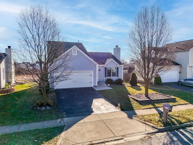 single story home with aphalt driveway, a garage, a chimney, and a front lawn