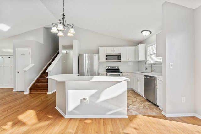 kitchen featuring a sink, light countertops, white cabinets, and stainless steel appliances