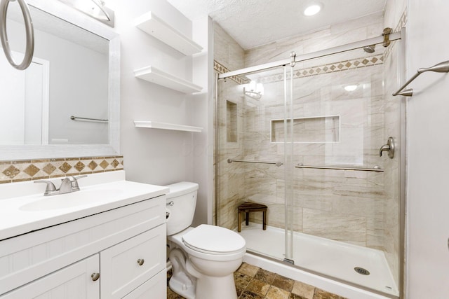 full bath featuring backsplash, a shower stall, toilet, vanity, and a textured ceiling