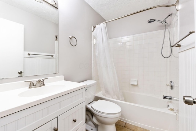 bathroom with tile patterned floors, toilet, a textured ceiling, shower / bath combination with curtain, and vanity