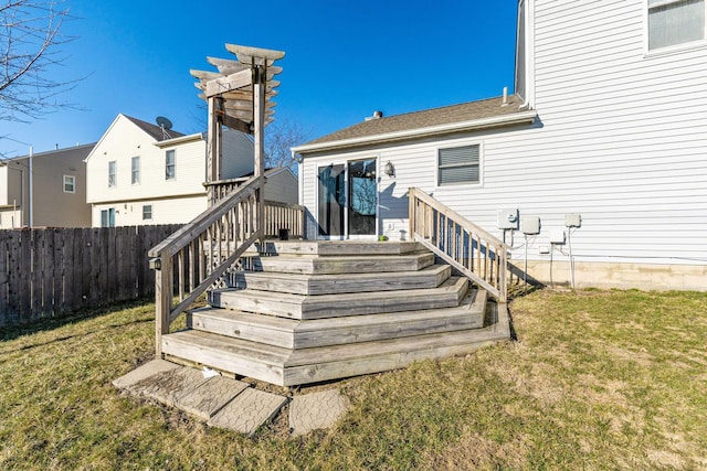 wooden deck featuring stairs, a yard, and fence