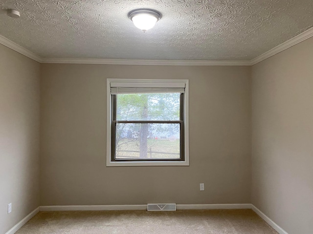 unfurnished room with a textured ceiling, baseboards, visible vents, and light carpet