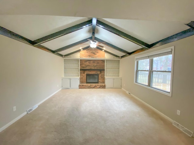 unfurnished living room featuring visible vents, built in shelves, baseboards, lofted ceiling with beams, and a fireplace