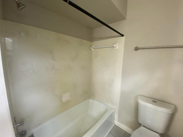 full bathroom featuring tub / shower combination, baseboards, toilet, and tile patterned flooring