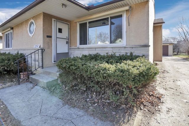 view of front of house with an outbuilding and stucco siding