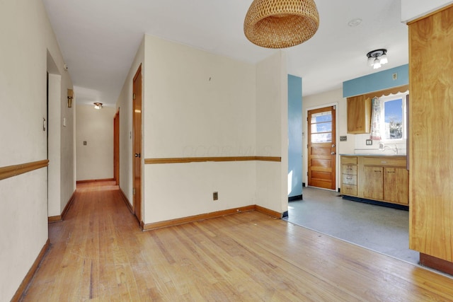 interior space featuring light wood-style flooring and baseboards