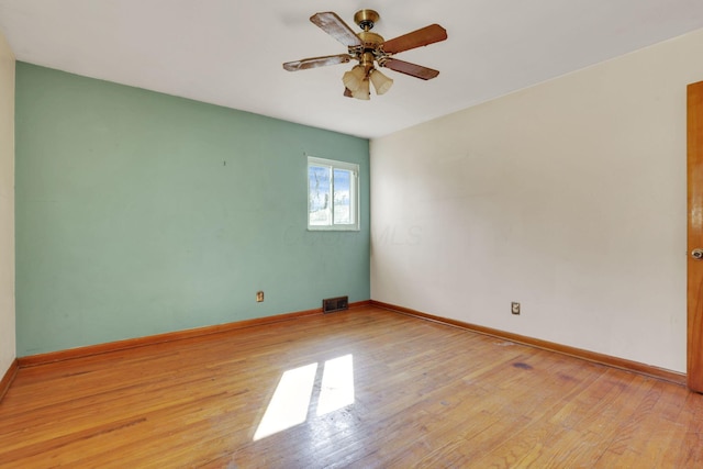 unfurnished room featuring baseboards, a ceiling fan, visible vents, and light wood-type flooring