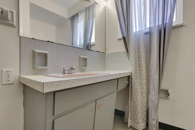 bathroom with vanity, tile walls, and backsplash