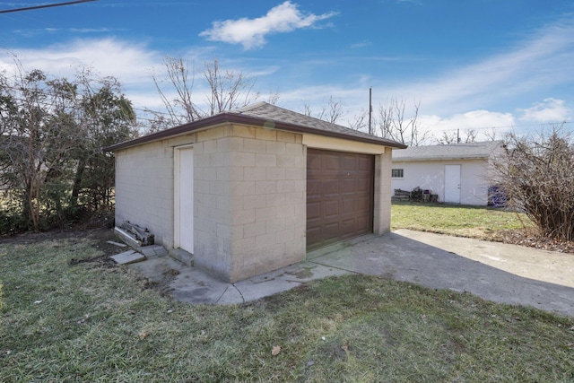 detached garage featuring driveway