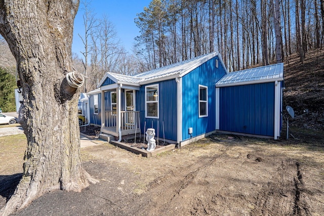 exterior space with an outbuilding and metal roof