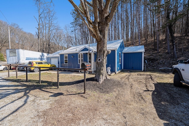 view of front of property with metal roof and an attached garage