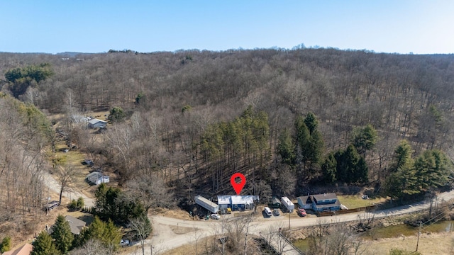 birds eye view of property with a forest view