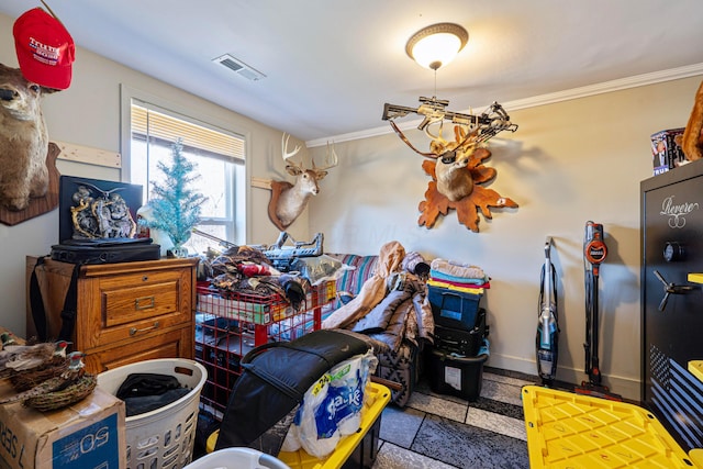 miscellaneous room with baseboards, visible vents, and ornamental molding