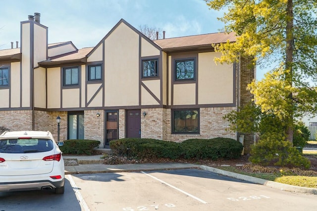 view of building exterior featuring uncovered parking