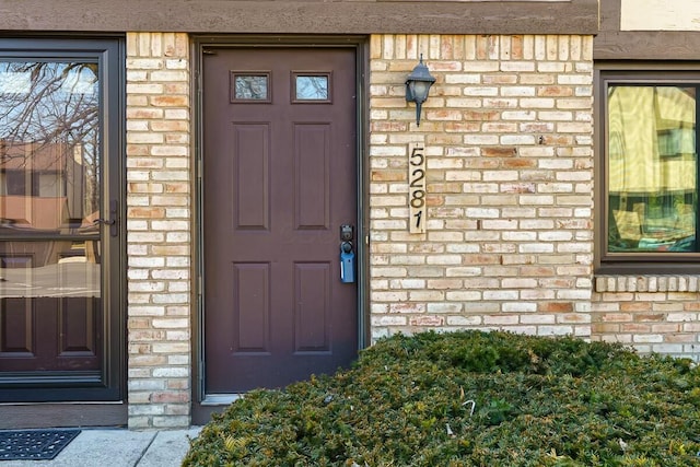 property entrance with brick siding