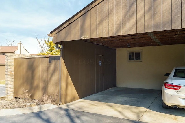 view of property exterior with stucco siding and a carport