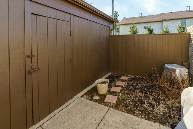 view of yard with central air condition unit and a fenced backyard